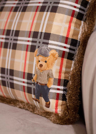 Checked decorative pillow with a teddy bear motif