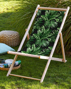 Black deck chair with tropical leaves
