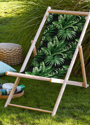 Black deck chair with tropical leaves