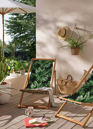 Black deck chair with tropical leaves