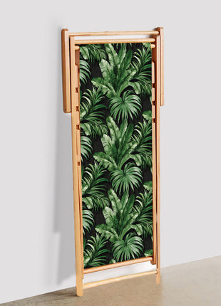 Black deck chair with tropical leaves